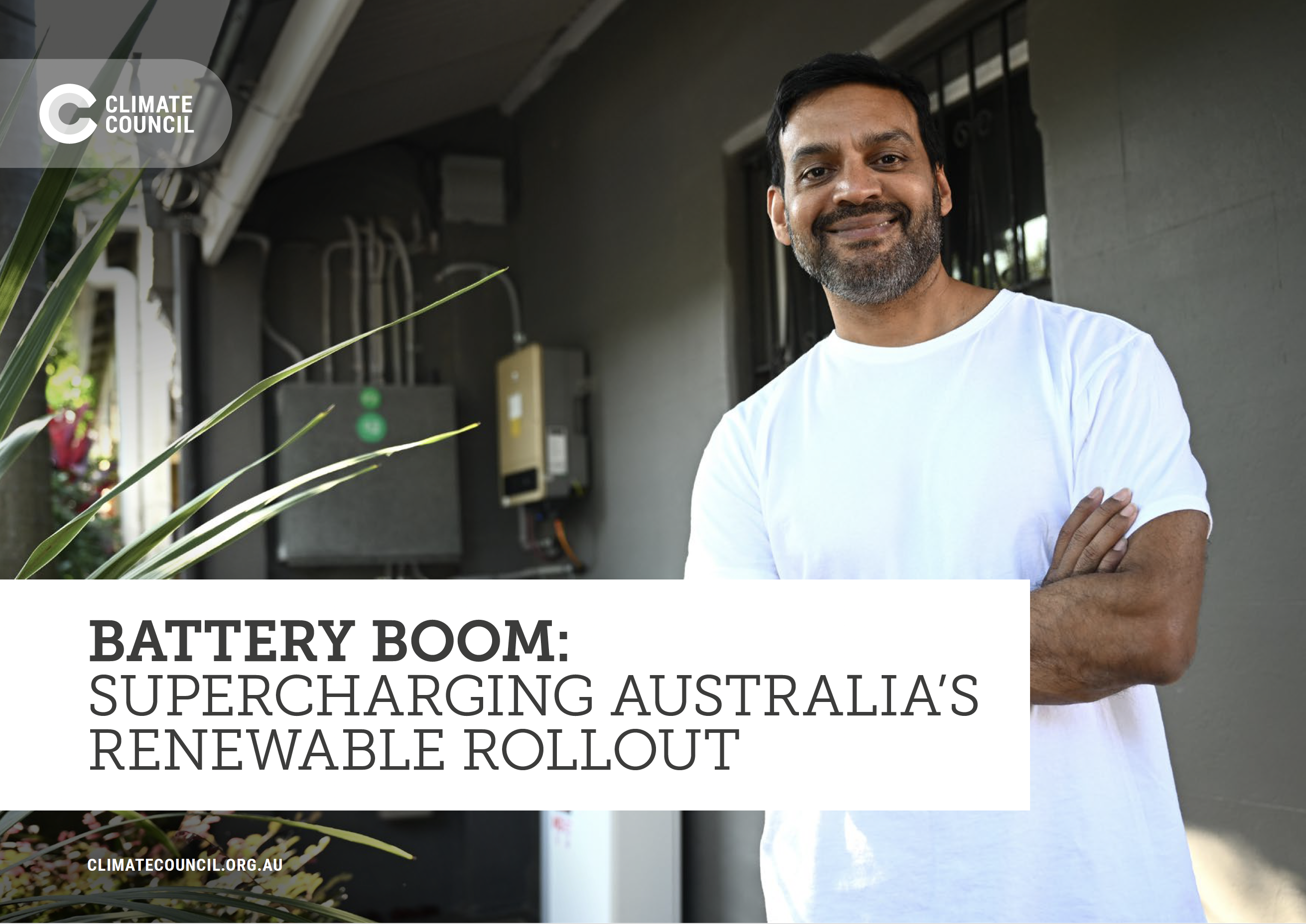 An image of the frontcover of the report: Battery Boom, featuring a smiling man in front of his house with a home battery in the background. 